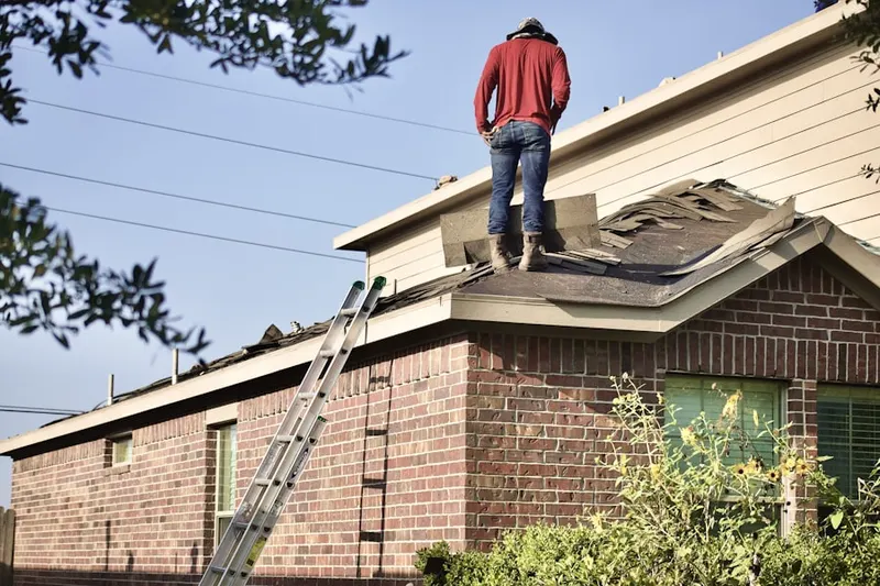 Professional roofer working on a residential roof in Riverdale Park